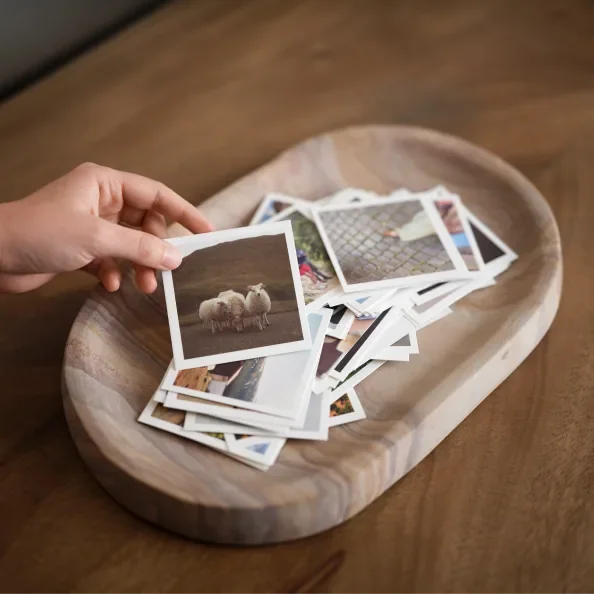 Printed photos in a wooden tray